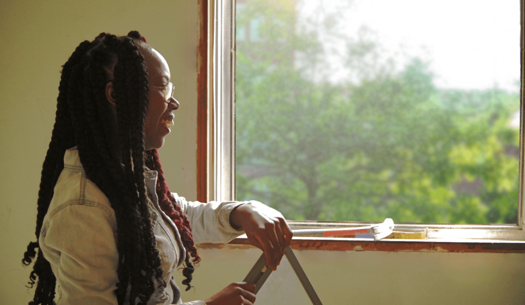 YCC YouthBuild member in Lake County after installing window.